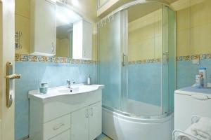 a bathroom with a shower and a sink and a toilet at Illusion Downtown Apartment in Belgrade +23 photos