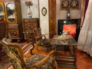 a living room with a table and chairs and a fireplace at WB Lounge - Mohandessin Apartment in Cairo