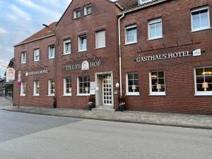 a red brick building with a christmas hotel on a street at Tilla's Hof in Hamm
