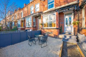 a table and chairs in front of a house at *RD12s* For your most relaxed & Cosy stay + Free Parking + Free Fast WiFi * in Headingley