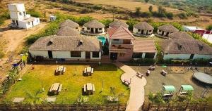 an aerial view of a large house with thatched roofs at The Village Resort in Kodāe