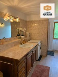 a bathroom with a sink and a washing machine at Maison Mayeras, 3 ch in Razès