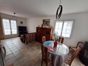 a living room with a table and a couch at Le boisnheur in Gap