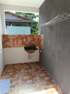 a bathroom with a sink in the corner of a room at Casa de Praia in Ubatuba