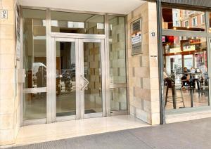 a store front with glass doors on a building at Bilocale Amendola 13 in Bologna
