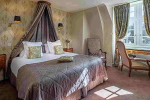 a bedroom with a bed with a canopy at Château De Pray in Amboise