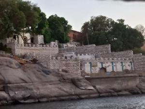 a stone building on the side of a river at Go Inn Backpackers in Aswan
