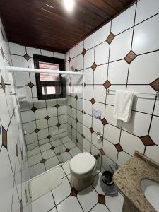 a bathroom with a toilet and a sink at Hotel D'Luz in Itapema