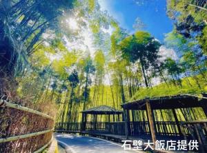 a painting of a park with a gazebo at Shi Bi Hotel in Gukeng