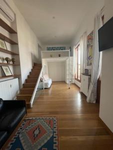 a living room with a staircase and a stair case at Casa Pagano Un pezzo di cielo su Milano in Milan