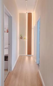 an empty room with white walls and a hard wood floor at Home Cinema - BM City Centre - 4km to Icon City at The Metropol Muji Style Apartment in Bukit Mertajam