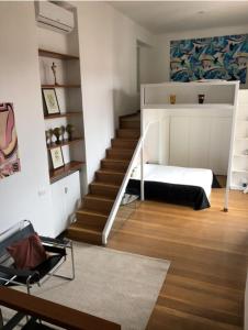 a bedroom with a bed and a staircase with a stair case at Casa Pagano Un pezzo di cielo su Milano in Milan