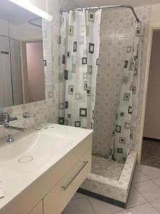 a bathroom with a shower curtain and a sink at Marilyn in Niederwil