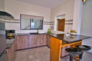 a kitchen with a counter with a sink and a window at Sunset Haven Villa in Beau Vallon