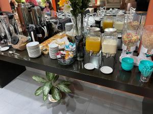 Hotel Bermudas في مار ديل بلاتا: طاولة مع أطباق وكؤوس من عصير البرتقال