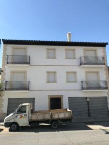 a white truck parked in front of a building at La casa de la avenida in Cenes de la Vega