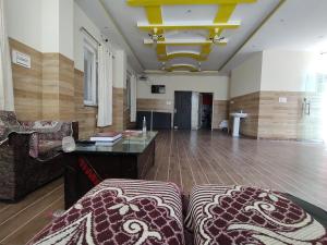 a living room with a couch and a table at Hotel Aman in Rishīkesh