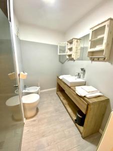 a bathroom with a toilet and a sink at Appartamento Ali&Dome centralissimo in Ancona