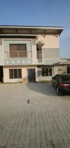 a car parked in a parking lot in front of a building at Luxury 4 Bdr Home in the city in Abuja