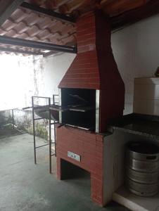 un horno de ladrillo en una habitación con mesa en Suíte Prainha, en Río de Janeiro