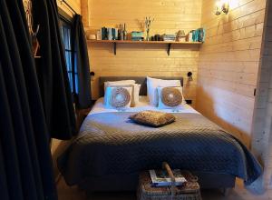 a small bedroom with a bed with pillows at Het Blij Hen in Oudenbosch