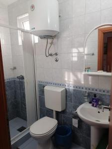 a bathroom with a toilet and a sink at Guest House Garden in Budva +39 photos