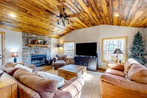 a living room with couches and a christmas tree at Pine Woods Cabin in McHenry