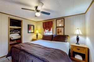 a bedroom with a bed and a ceiling fan at Pine Woods Cabin in McHenry