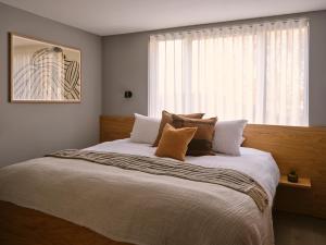 a bedroom with a large bed with a window at The Marloes in London