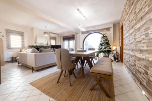 a living room with a table and a christmas tree at Excellent House in Tríkala