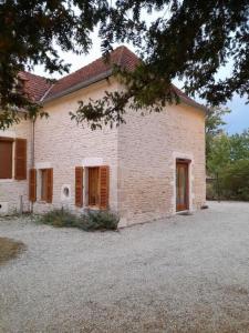 a large white brick building with two doors on it at Gîte Napoléon in Dienville
