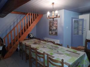 a dining room with a table and a staircase at Gîte Napoléon in Dienville +9 photos