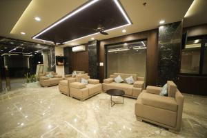 a lobby with couches and a table in a building at Maruti Group of Hotels - The Shivam in Nāthdwāra