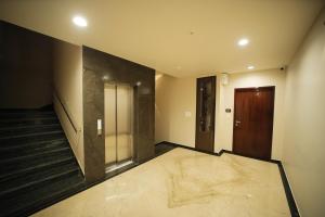an empty room with a door and a hallway at Maruti Group of Hotels - The Shivam in Nāthdwāra