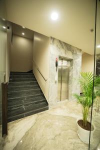 a elevator in a building with a potted plant at Maruti Group of Hotels - The Shivam in Nāthdwāra