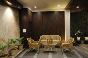 a table and two chairs and a table and a table and chairs at Maruti Group of Hotels - The Shivam in Nāthdwāra
