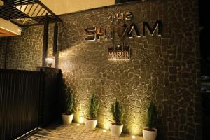 a group of potted plants on the side of a building at Maruti Group of Hotels - The Shivam in Nāthdwāra