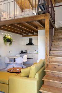 a living room with a yellow couch and a staircase at Malathro Olympus Guest House in Díon
