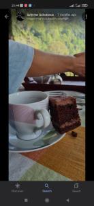 a plate with a cup of coffee and a piece of cake at Rose Dale Homestay Ella in Ella