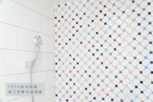 a shower curtain in a bathroom with a shower head at 衛民居 wei min stay in Tainan +45 photos