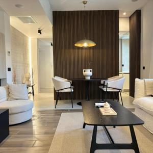 a living room with a couch and a table at Ostia Holiday Kama Wellness Home in Lido di Ostia