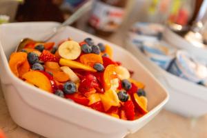 a bowl filled with fruit and vegetables on a table at Hotel Alesi in Malcesine