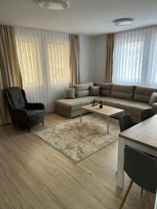 a living room with a couch and a table at CENTRAL Aparments in Novi Pazar