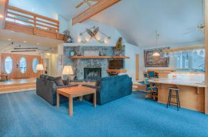 a living room with a couch and a fireplace at Red Cedar - Unit 30 in Sunriver