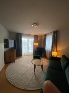 a living room with a couch and a coffee table at Chalet Toda in Lech am Arlberg