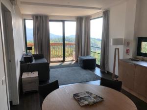 a living room with a table and a large window at Agriturismo Voeuja Lago Maggiore in Luino