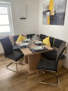 a dining room table with chairs and a table and chairsktop at Apart Kofler in Längenfeld