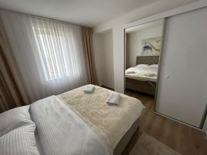 a bedroom with a mirror and a bed in it at CENTRAL Aparments in Novi Pazar