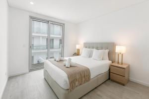 En eller flere senge i et værelse på Casa das Ondas