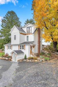 a large white house sitting on the side of a street at Underground Railroad 3 Bedroom Farmhouse in Kennett Square